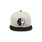 Baseball-style cap with a pinstriped design and a yin-yang smiley face logo on the front.