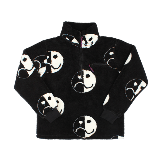 Black fleece jacket with white smiley and frowny face designs.