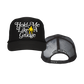 Black trucker hat with white text ’Hold Me Like A Grudge’ and a yellow symbol.