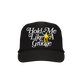 Black baseball cap with white text ’Hold Me Like A Grudge’ and a yellow hand icon.