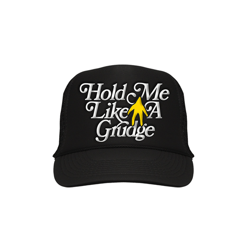 Black baseball cap with white text ’Hold Me Like A Grudge’ and a yellow hand icon.